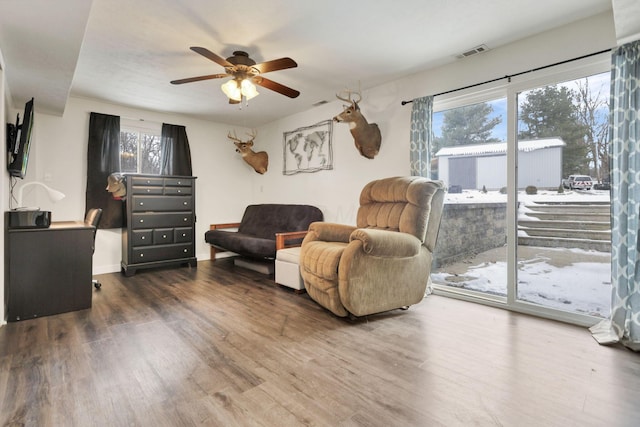 living room with hardwood / wood-style floors and ceiling fan