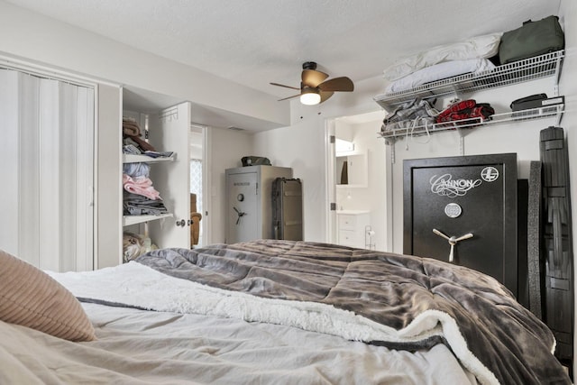 bedroom featuring a textured ceiling, ceiling fan, and ensuite bathroom