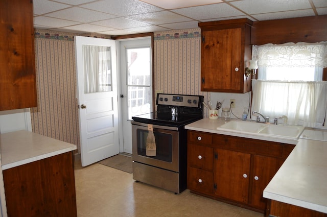 kitchen featuring sink, electric range, plenty of natural light, and a drop ceiling