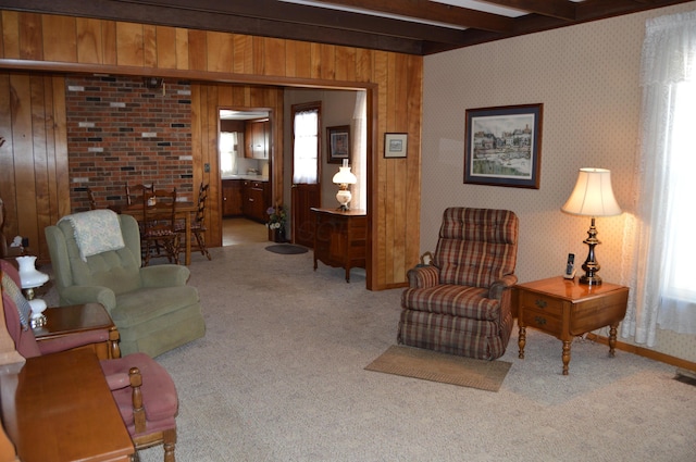 carpeted living room featuring wood walls and beam ceiling