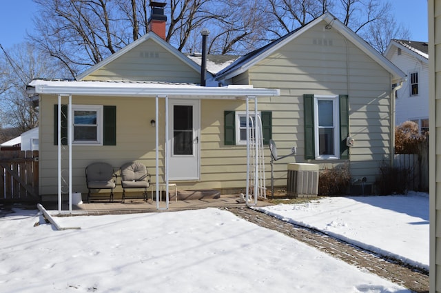 bungalow-style house with cooling unit