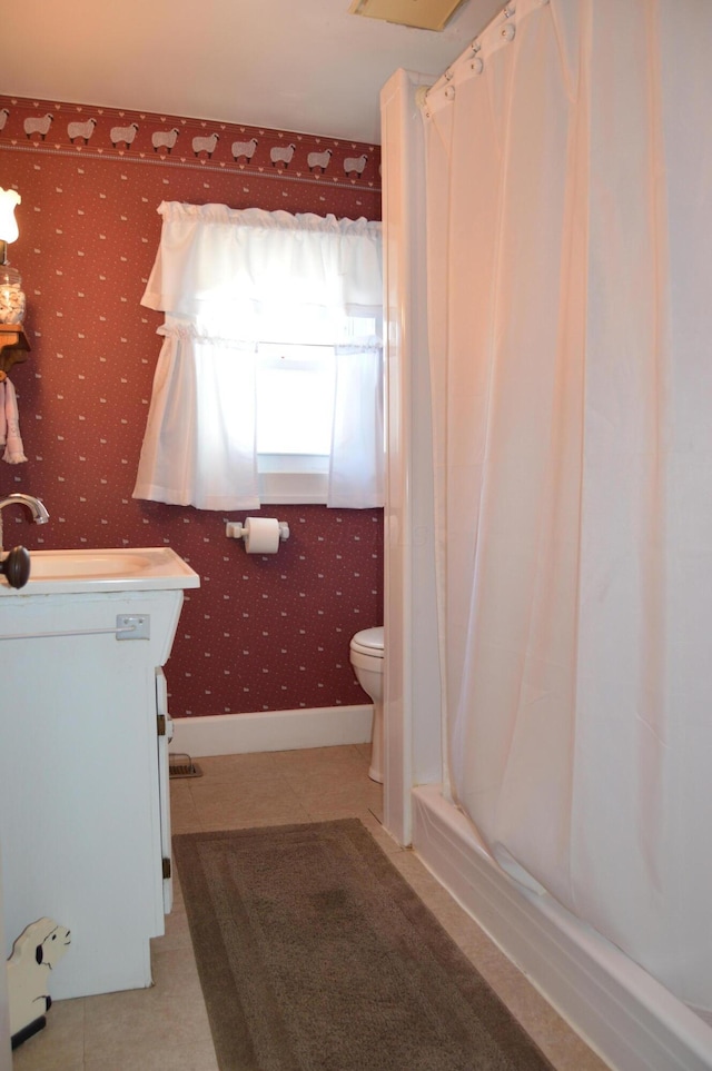 bathroom with toilet, tile patterned flooring, and vanity