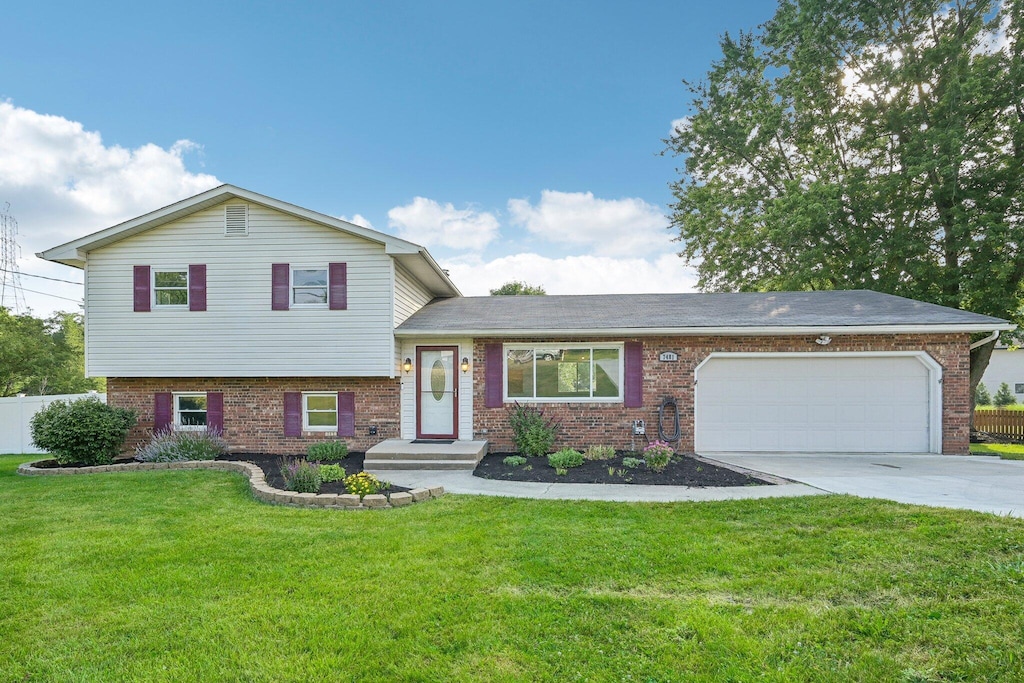 split level home with a garage and a front yard