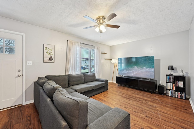 living room with ceiling fan, a textured ceiling, and hardwood / wood-style floors