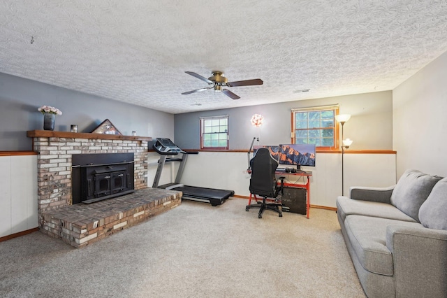 office area featuring carpet floors, a textured ceiling, and ceiling fan