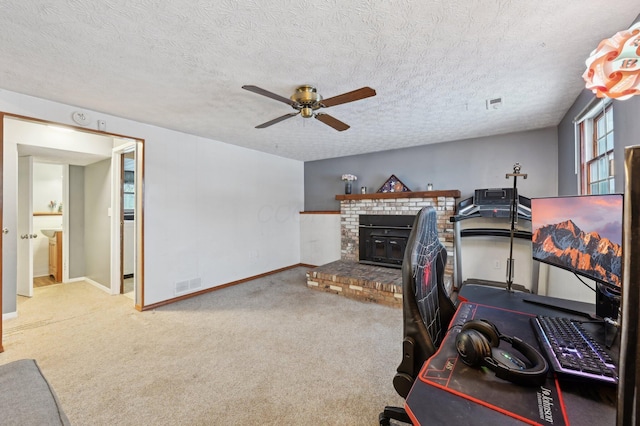 workout room with ceiling fan, carpet floors, and a textured ceiling