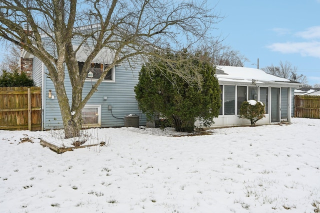 snow covered property featuring central air condition unit