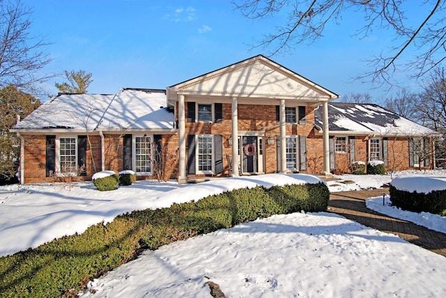 neoclassical home with brick siding