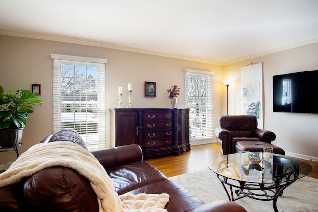 living room with ornamental molding, baseboards, and wood finished floors