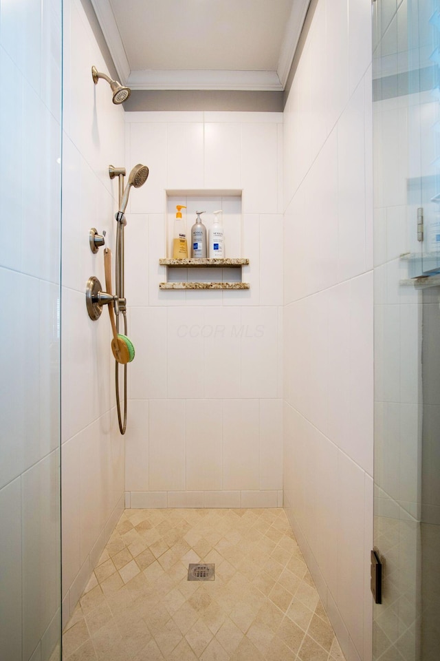 full bath featuring a stall shower and crown molding