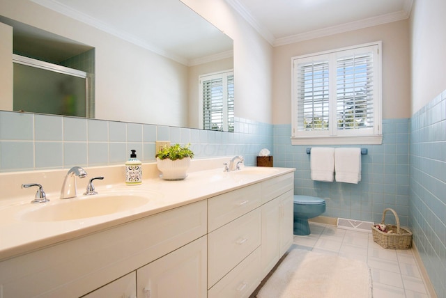 full bathroom with crown molding, a sink, tile walls, and a shower stall