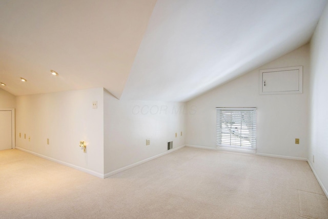 bonus room with baseboards, visible vents, vaulted ceiling, and light colored carpet