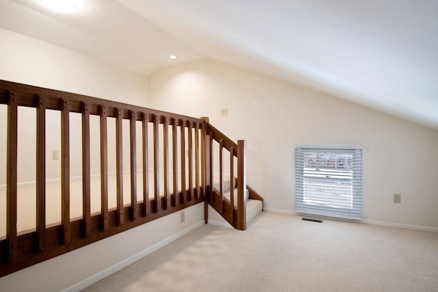 staircase with baseboards, visible vents, lofted ceiling, carpet flooring, and recessed lighting