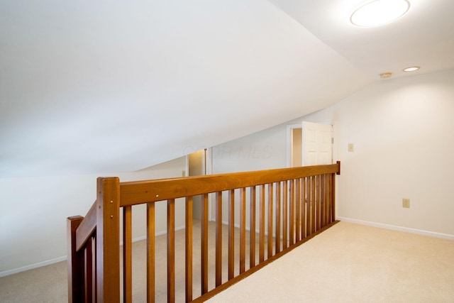 hall with carpet, vaulted ceiling, baseboards, and recessed lighting