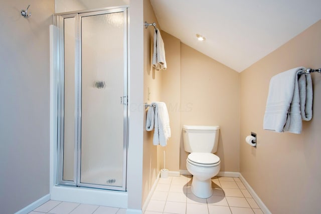 bathroom featuring toilet, baseboards, vaulted ceiling, a shower stall, and tile patterned floors