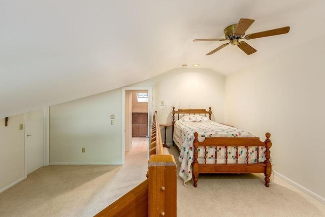 bedroom with lofted ceiling, baseboards, a ceiling fan, and light colored carpet