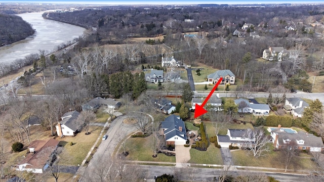 aerial view featuring a water view, a residential view, and a wooded view