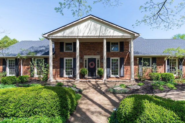 4580 Helston Ct, Columbus, OH 43220 - neoclassical home featuring brick siding, roof with shingles, and covered porch