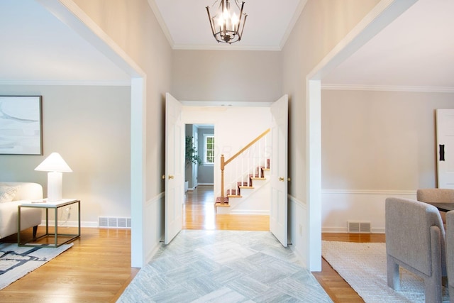 4580 Helston Ct, Columbus, OH 43220 - entryway with stairway, a chandelier, crown molding, light wood-style floors, and baseboards