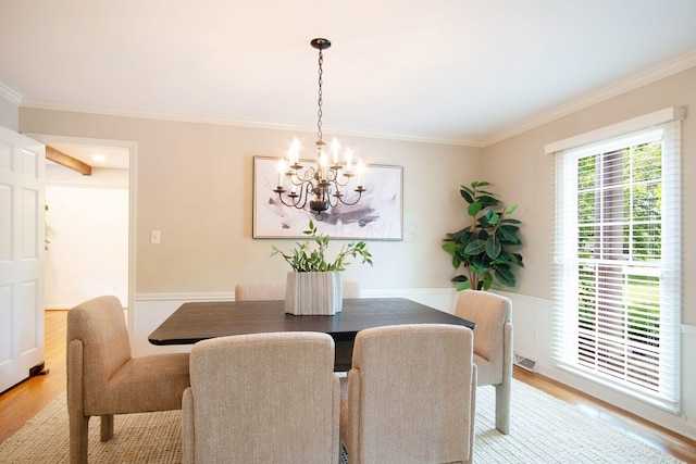 4580 Helston Ct, Columbus, OH 43220 - dining area featuring a chandelier, crown molding, and light wood-style flooring