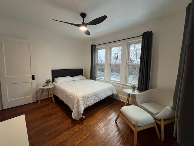 bedroom featuring ceiling fan and dark wood-type flooring