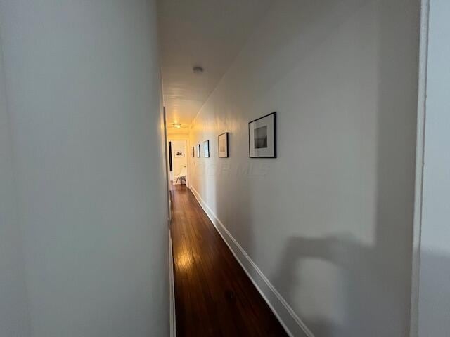 hallway with hardwood / wood-style floors