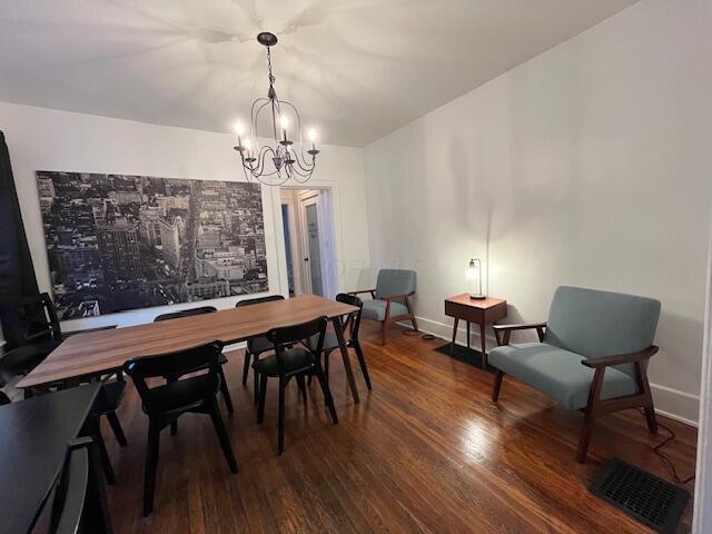 dining room featuring hardwood / wood-style floors and a chandelier