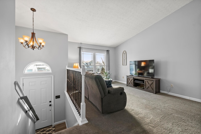 carpeted living room with a textured ceiling, an inviting chandelier, lofted ceiling, and a healthy amount of sunlight