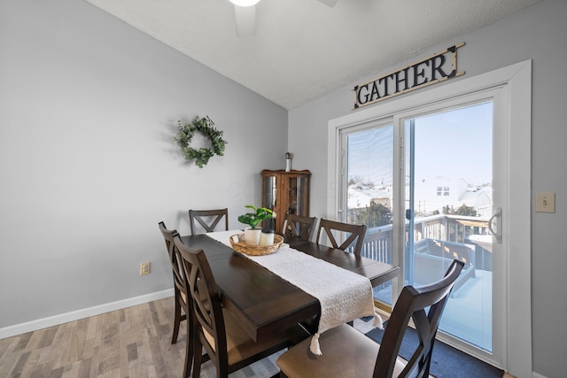 dining area with ceiling fan, lofted ceiling, and hardwood / wood-style floors