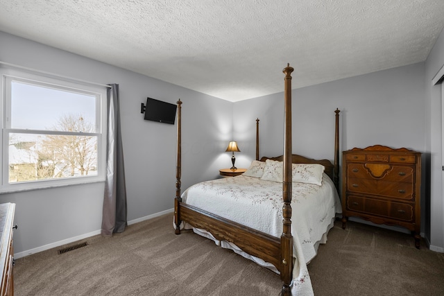 bedroom featuring carpet and a textured ceiling