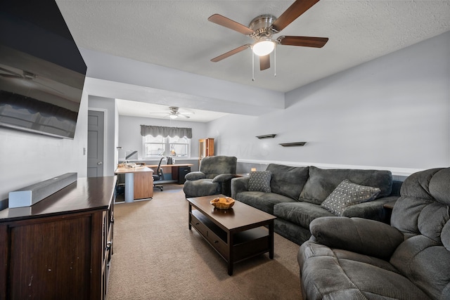 living room with light carpet, ceiling fan, and a textured ceiling