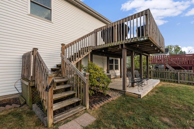 wooden deck with a lawn