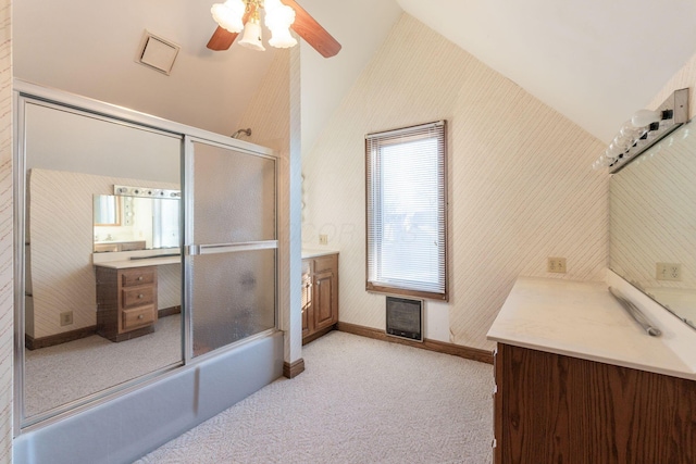 bathroom with vaulted ceiling, ceiling fan, vanity, and shower / bath combination with glass door