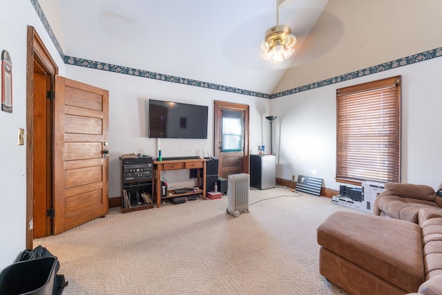 living room featuring ceiling fan, light colored carpet, and vaulted ceiling