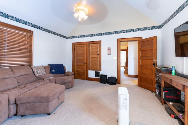 carpeted living room featuring ceiling fan and lofted ceiling