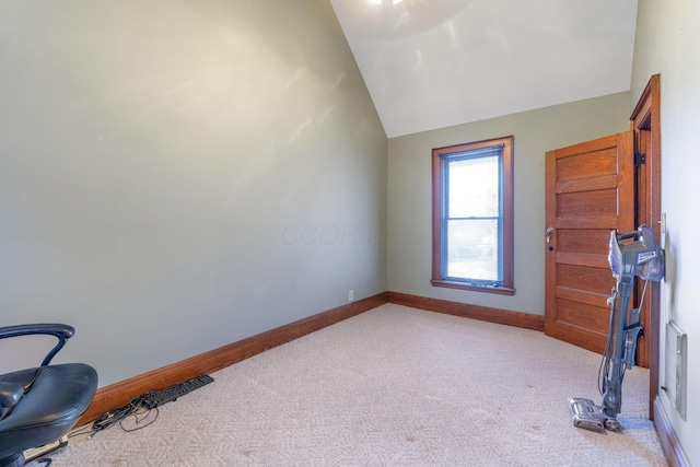 unfurnished room with light colored carpet and vaulted ceiling