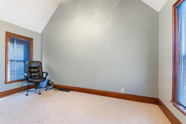 home office featuring carpet floors and vaulted ceiling