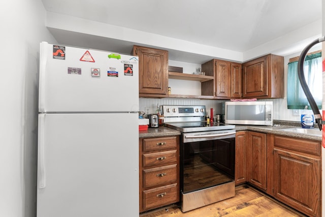 kitchen featuring stainless steel appliances and light hardwood / wood-style flooring