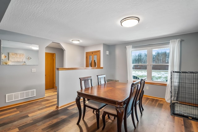 dining space featuring dark wood-type flooring