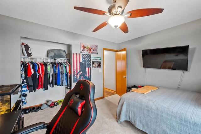 carpeted bedroom featuring ceiling fan and a closet