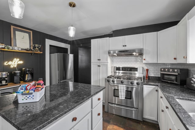 kitchen with decorative backsplash, sink, white cabinetry, hanging light fixtures, and appliances with stainless steel finishes