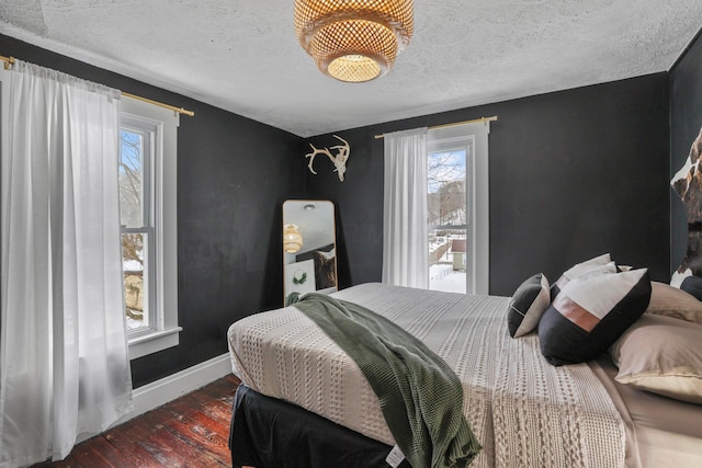 bedroom featuring dark hardwood / wood-style flooring and a textured ceiling