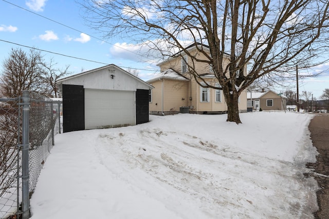 view of front of property with a garage and an outbuilding