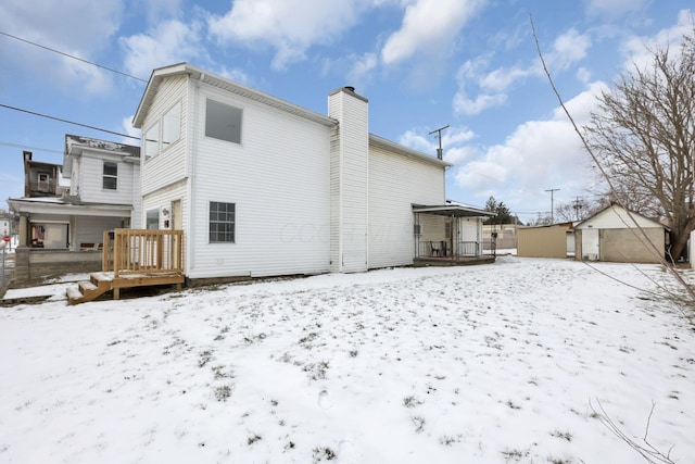 view of snow covered rear of property