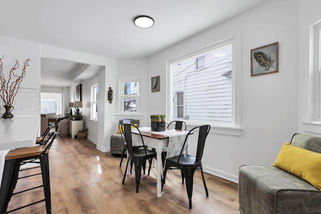 dining space with hardwood / wood-style floors