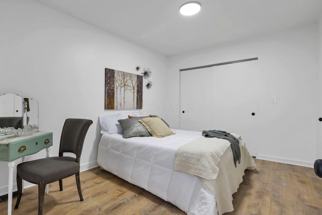 bedroom featuring hardwood / wood-style floors and a closet