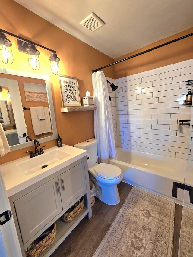 full bathroom with toilet, vanity, shower / bath combo with shower curtain, and hardwood / wood-style floors