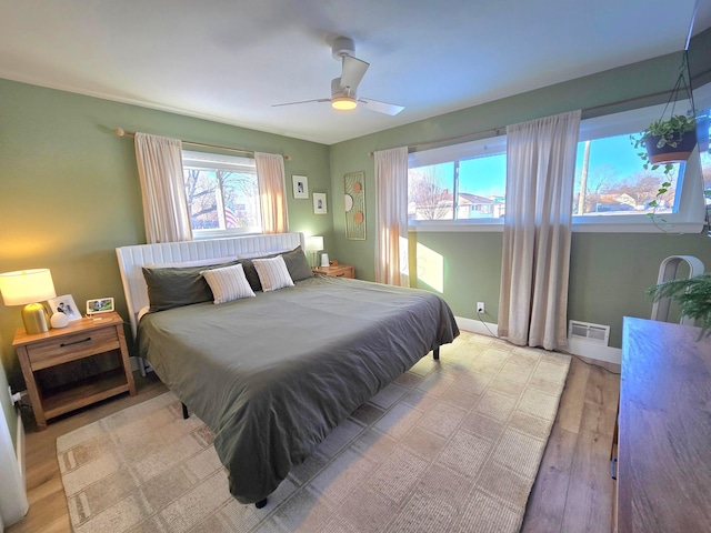 bedroom with ceiling fan and light hardwood / wood-style floors