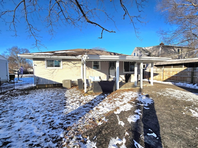 snow covered property with a patio area