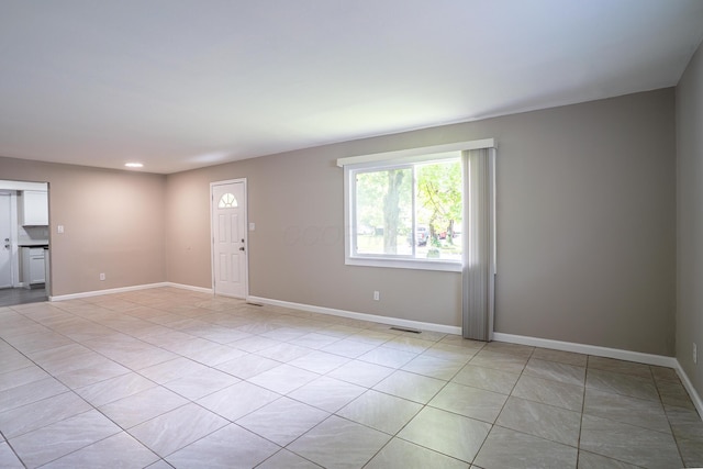 unfurnished living room featuring baseboards, recessed lighting, visible vents, and light tile patterned flooring
